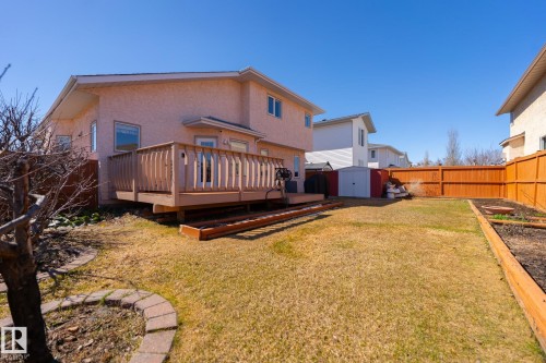 Expansive backyard featuring a wood deck, manicured lawn, and raised garden beds - 5736 161 Avenue, Edmonton, AB - Outdoor With Deck Patio Veranda With Exterior