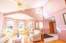Vaulted ceiling living area featuring multiple arch-top windows, wood-finish flooring, and a decorative chandelier - 5736 161 Avenue, Edmonton, AB  - Indoor Photo Showing Living Room 