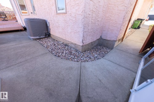 Stucco exterior with concrete patio and gravel landscaping - 5736 161 Avenue, Edmonton, AB - Outdoor