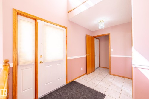 Entryway featuring a white paneled door with a matching sidelight, both equipped with pleated blinds - 5736 161 Avenue, Edmonton, AB - Indoor Photo Showing Other Room
