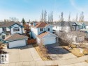 Light blue two-story residence featuring a two-car attached garage, brown shingle roofing, and a concrete driveway - 7 Doucette Place, St. Albert, AB  - Outdoor 