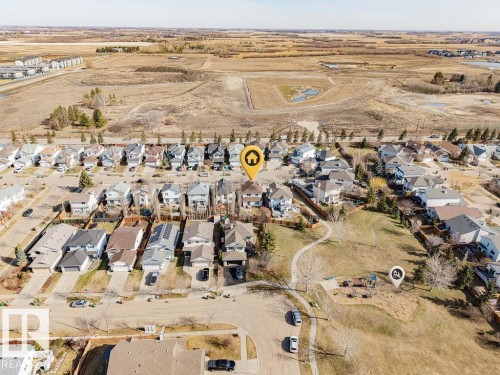 Aerial perspective of a residential neighborhood featuring detached homes with varied architectural styles and roofing materials - 7 Doucette Place, St. Albert, AB - Outdoor With View