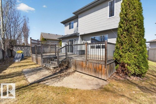 Multi-level wooden deck with lattice railing, featuring steps to a lower concrete patio - 10 Erickson Close, St. Albert, AB - Outdoor With Exterior