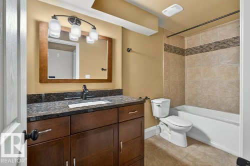 Bathroom featuring a dark wood-finish vanity with a granite countertop and integrated sink - 10 Erickson Close, St. Albert, AB - Indoor Photo Showing Bathroom