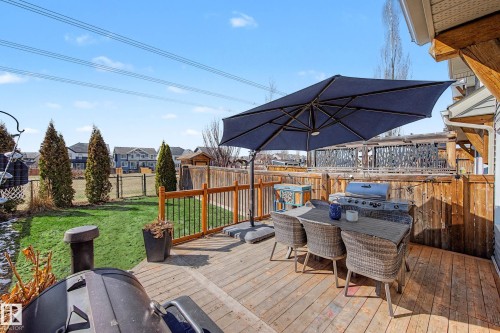 Spacious wood deck featuring a natural wood railing and privacy fence - 2083 Chalmers Way, Edmonton, AB - Outdoor With Deck Patio Veranda