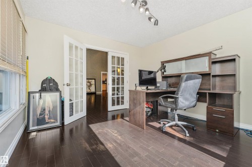 Room featuring dark wood-finish flooring, light neutral-toned walls, and a textured ceiling - 6016 177 Street, Edmonton, AB - Indoor Photo Showing Office