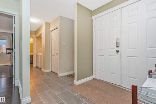 Entryway featuring grey rectangular floor tiles and white baseboards - 6016 177 Street, Edmonton, AB - Indoor Photo Showing Other Room