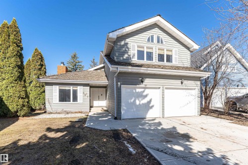 Exterior featuring light gray siding, white trim, an attached two-car garage, and a concrete driveway - 6016 177 Street, Edmonton, AB - Outdoor