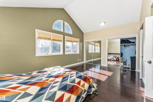 Vaulted ceilings featuring an arched transom window and two rectangular windows with wood blinds - 6016 177 Street, Edmonton, AB - Indoor Photo Showing Bedroom