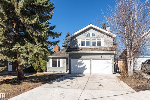 Two-story residence featuring gray siding and shingle accents, a two-car garage, and a concrete driveway - 6016 177 Street, Edmonton, AB - Outdoor