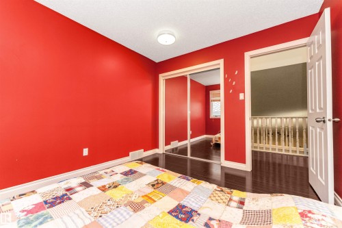 Interior room featuring dark wood-finish flooring and a ceiling-mounted light fixture - 6016 177 Street, Edmonton, AB - Indoor Photo Showing Bedroom