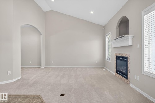 Living space featuring a vaulted ceiling and recessed lighting - 34 3003 34 Avenue, Edmonton, AB - Indoor With Fireplace