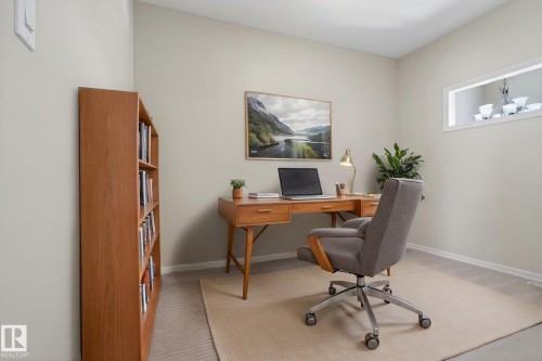 Recessed wall niche, built-in shelving, carpet flooring, and light-toned wall paint - 34 3003 34 Avenue, Edmonton, AB - Indoor Photo Showing Office