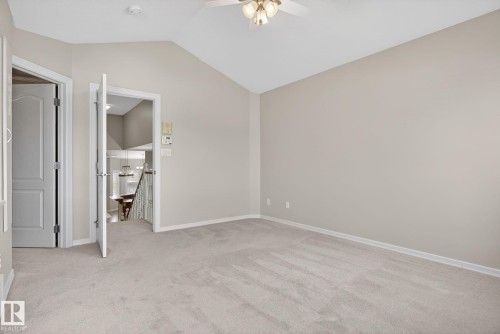 Vaulted ceiling room with neutral carpeting and paint - 34 3003 34 Avenue, Edmonton, AB - Indoor Photo Showing Other Room