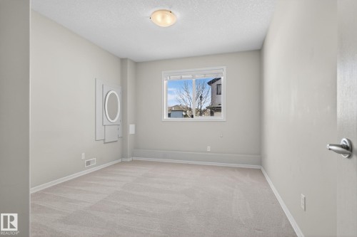 Neutral-toned room featuring a single window, light-colored carpet, and a flush-mount ceiling light fixture - 34 3003 34 Avenue, Edmonton, AB - Indoor Photo Showing Other Room