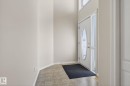Entryway featuring a decorative oval glass door with sidelight, transom windows, neutral wall tones, and ceramic tile flooring - 34 3003 34 Avenue, Edmonton, AB  - Indoor Photo Showing Other Room 