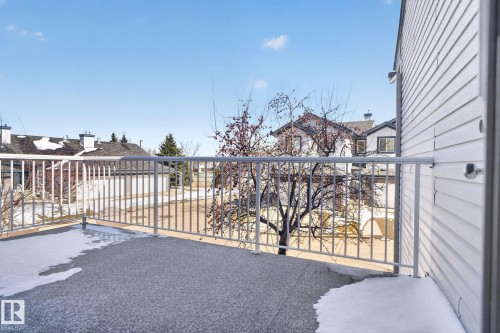 Exterior balcony featuring a textured concrete surface, white metal railings, and vinyl siding - 34 3003 34 Avenue, Edmonton, AB - Outdoor With Balcony