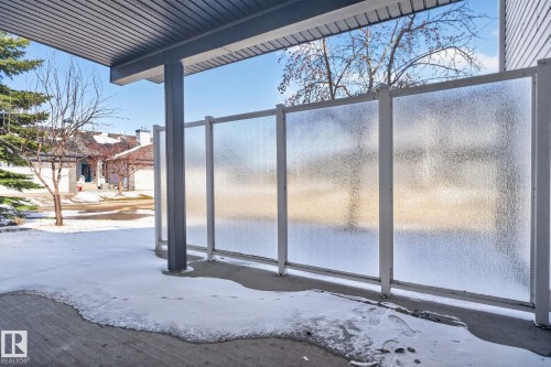 Patio area featuring frosted privacy panels, a covered ceiling, and a supporting column - 34 3003 34 Avenue, Edmonton, AB - Outdoor