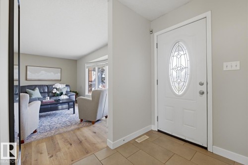 Entryway featuring a white door with an oval leaded glass insert, tile flooring, and light gray wall paint - 17604 85 Avenue, Edmonton, AB - Indoor Photo Showing Other Room