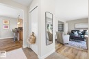 Entryway featuring tile flooring, leading to a living area with wood-finish flooring and a kitchen beyond - 17604 85 Avenue, Edmonton, AB  - Indoor 
