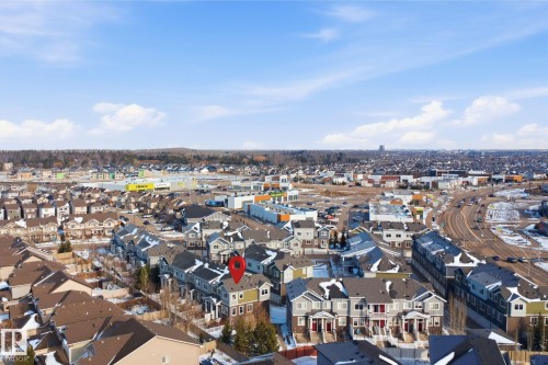 Townhome community featuring varied architectural styles and mixed-use commercial areas - 33 7385 Edgemont Way Nw, Edmonton, AB - Outdoor With View