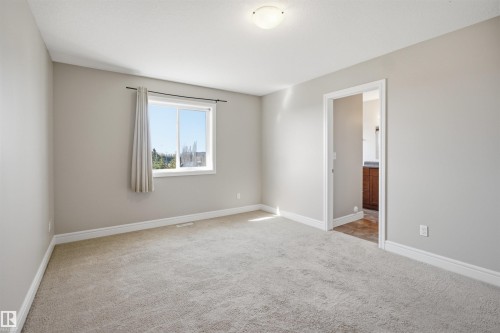Carpeted room with neutral wall tones and white baseboards - 19 15151 43 Street, Edmonton, AB - Indoor Photo Showing Other Room