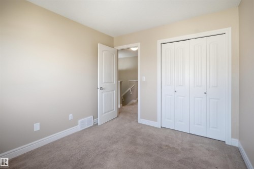 Carpeted room with neutral wall paint and white trim - 19 15151 43 Street, Edmonton, AB - Indoor