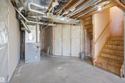 Unfinished basement space featuring a concrete floor, exposed wood framing, and insulation - 19 15151 43 Street, Edmonton, AB - Indoor Photo Showing Basement