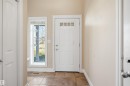 Entryway featuring tiled flooring, a white paneled entry door with transom lites, and a sidelite window - 19 15151 43 Street, Edmonton, AB  - Indoor Photo Showing Other Room 