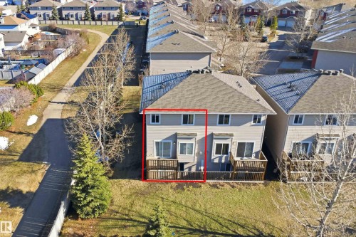 Multi-story residence featuring a neutral-toned exterior, a shingled roof, and a private wooden deck - 19 15151 43 Street, Edmonton, AB - Outdoor