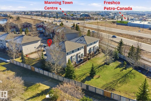 Two-story residential building with light-colored siding and a dark shingle roof - 19 15151 43 Street, Edmonton, AB - Outdoor With View