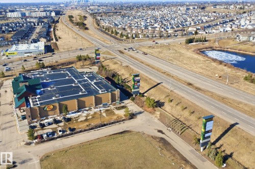 Commercial retail building featuring extensive parking, prominent highway frontage, and multiple large-format signage structures - 19 15151 43 Street, Edmonton, AB - Outdoor With View