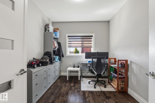 Dedicated workspace featuring wood-finish flooring, a window with horizontal blinds, and recessed ceiling lighting - 731 57 Street Sw, Edmonton, AB - Indoor Photo Showing Office