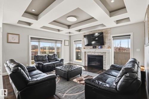 Living room with a coffered ceiling and recessed lighting - 731 57 Street Sw, Edmonton, AB - Indoor Photo Showing Living Room With Fireplace