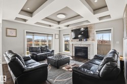 Living room with a coffered ceiling and recessed lighting - 