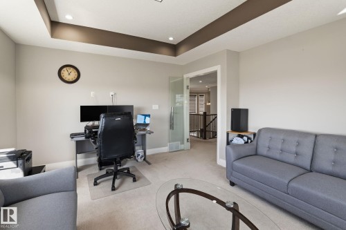 Carpeted room featuring a tray ceiling with recessed lighting - 731 57 Street Sw, Edmonton, AB - Indoor Photo Showing Other Room