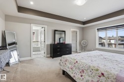 Spacious room featuring carpet flooring and a tray ceiling with recessed lighting - 