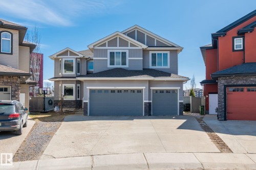Two-story residential architecture with light gray siding and dark gray trim - 731 57 Street Sw, Edmonton, AB - Outdoor With Facade