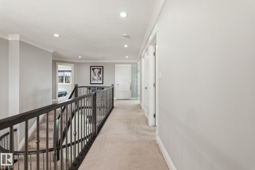 Upper-level hallway featuring neutral carpeting, recessed lighting, and crown molding - 731 57 Street Sw, Edmonton, AB - Indoor Photo Showing Other Room