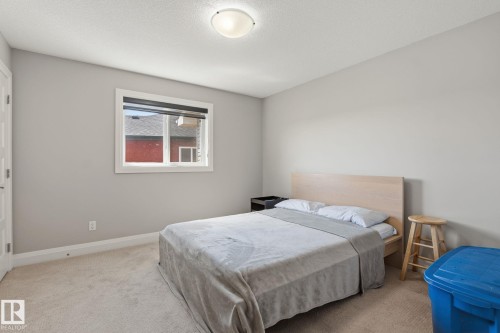 Bedroom featuring neutral wall paint, light-toned carpeting, and a single window with blinds - 731 57 Street Sw, Edmonton, AB - Indoor Photo Showing Bedroom