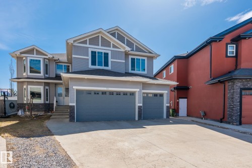 Contemporary two-story residence featuring light gray siding and stone accents - 731 57 Street Sw, Edmonton, AB - Outdoor With Facade