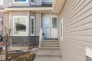 Light-toned horizontal siding exterior featuring a decorative glass double entry door - 731 57 Street Sw, Edmonton, AB  - Outdoor With Exterior 