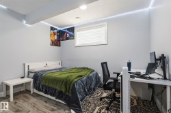 Spacious room featuring wood-finish flooring, a contemporary window with blinds, recessed ceiling lighting, and light gray wall paint - 
