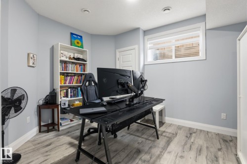 Room with light wood-finish flooring and light blue wall paint - 731 57 Street Sw, Edmonton, AB - Indoor Photo Showing Office
