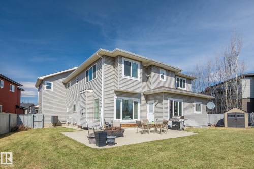 Spacious backyard featuring a concrete patio, well-maintained lawn, and a storage shed - 731 57 Street Sw, Edmonton, AB - Outdoor