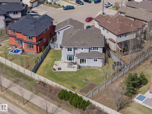 Spacious backyard featuring a manicured lawn, a concrete patio, and garden beds - 731 57 Street Sw, Edmonton, AB - Outdoor