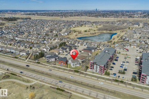 Aerial perspective showcasing a residential area with a prominent central property - 731 57 Street Sw, Edmonton, AB - Outdoor With View