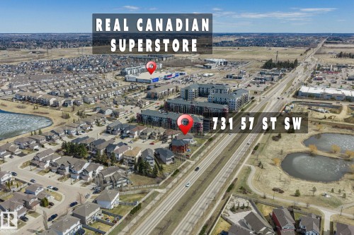Aerial perspective showcasing a residential area with varied housing types, proximity to a commercial center, and multiple bodies of water - 731 57 Street Sw, Edmonton, AB - Outdoor With View