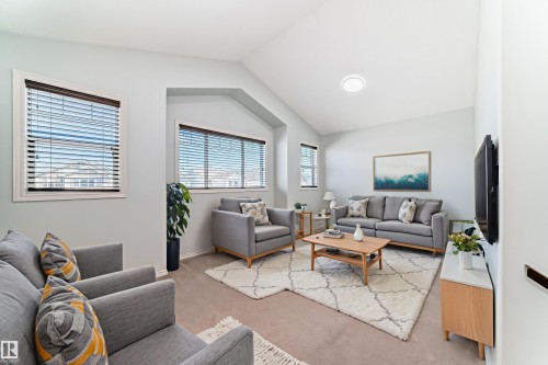Living area with vaulted ceilings, recessed lighting, and multiple windows with blinds - 6723 19 Avenue, Edmonton, AB 