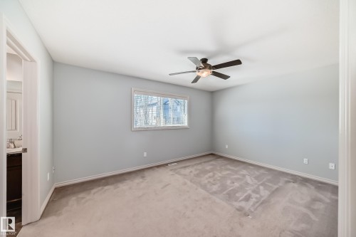 Bedroom featuring neutral gray wall paint, a ceiling fan with integrated lighting, a window with blinds, and light-colored carpeting - 6723 19 Avenue, Edmonton, AB 